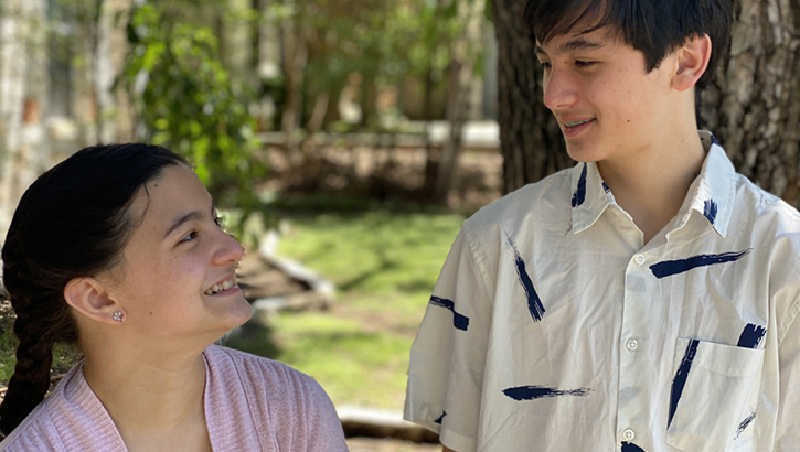 Image of Sister and brother smiling at each other. Click to open a larger version of the image.