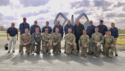 U.S. Air Force Capt. Joseph McIlvaine and Capt. Ryan Taylor, centered front row, pose with fellow aeromedical physician assistants and their assigned instructor pilots during hands-on flight training