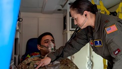 Air Force Maj. Elizabeth Kuss, 325th Operational Medical Readiness Squadron flight medicine flight commander, performs a check up on military personnel