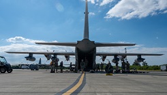U.S. Air Force Airmen with the 18th Medical Group and the 18th Aeromedical Evacuation Squadron transfer simulated patients during a mass-casualty scenario exercise