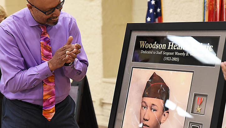 Stephen Woodson looks at a painting of his father