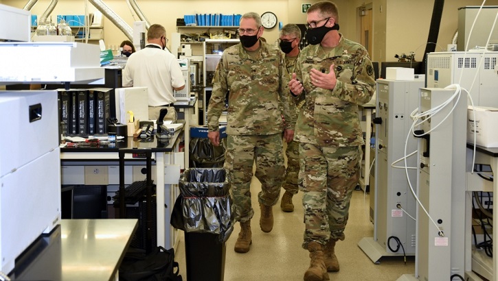 Image of Military personnel explaining forensic equipment.