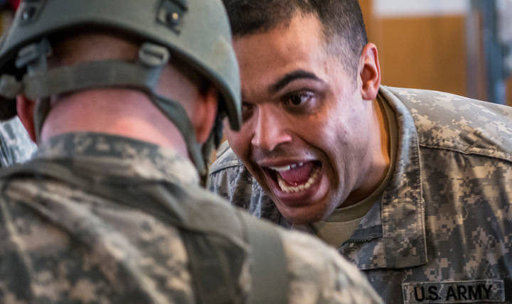 Staff Sgt. Gordon Smith, senior Army Reserve medic for the 321st Engineer Battalion, drills questions in the face of a student medic during a training scenario, as part of an 18-day Sapper Advanced Tactical Medical Course taught at Gowen Field Air National Guard Base, Idaho, in January, 2015. (U.S. Army photo by Sgt. 1st Class Michel Sauret)