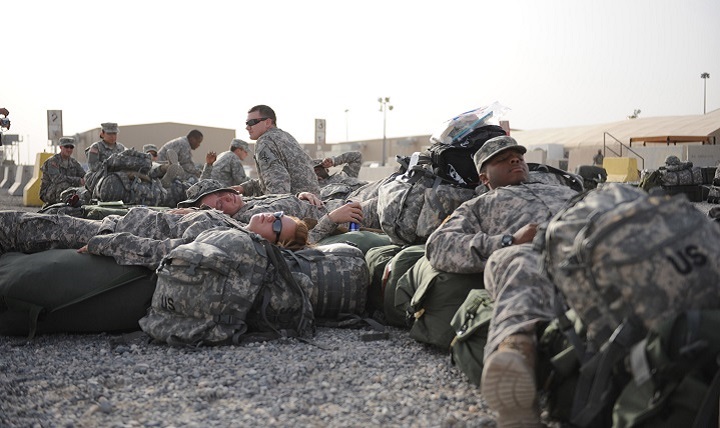Soldiers from the 824th Quarter Master Company find a convenient place to rest while waiting for transportation to their deployment.