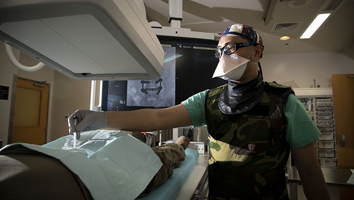 U.S. Air Force Maj. (Dr.) Matthew Taon, interventional radiologist, demonstrates a minimally invasive image guided procedure at Brooke Army Medical Center, Fort Sam Houston, Texas. (Photo by Jason W. Edwards, Brooke Army Medical Center)