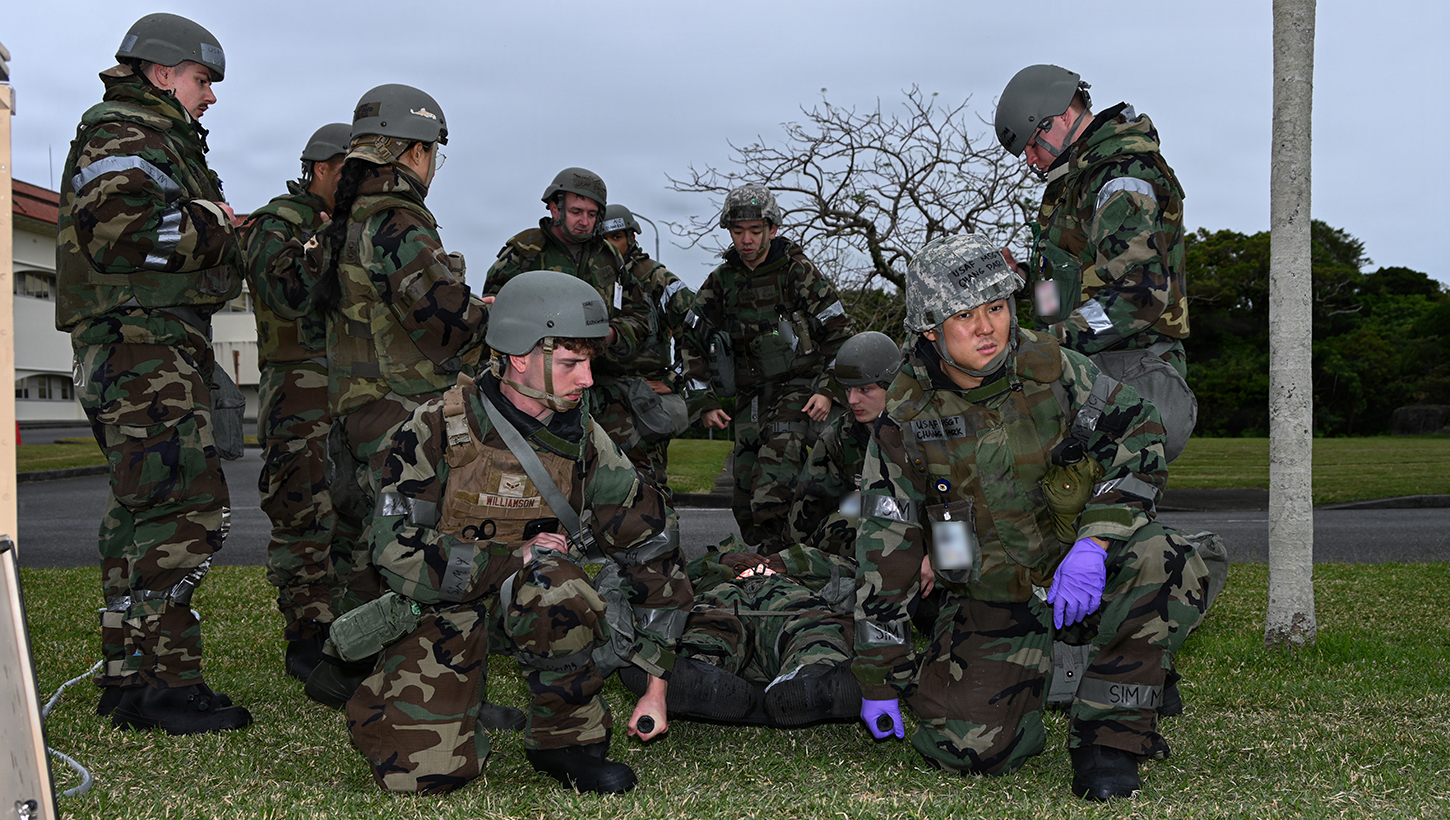 U.S. Sailors with 3rd Medical Battalion, 3rd Marine Logistics Group, and U.S. Air Force Airmen with 18th Medical Group, 18th Wing, treat a simulated patient during Exercise Beverly Midnight 26 at Kadena Air Base, Okinawa, Japan, March 12, 2026. 3rd Medical Battalion provided medical support during BM26, enabling the 18th Wing to test its response capabilities. 