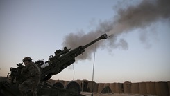 A soldier with the 82nd Airborne Division fires a howitzer during a range exercise.