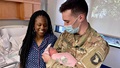 A soldier meets his new baby.