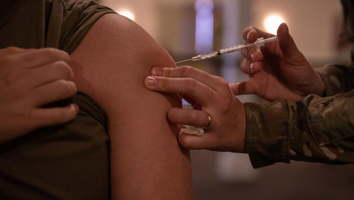 Image of A female airman being injected into her arm with her first COVID-19  vaccination at Barksdale Air Force Base, Shreveport, Louisiana Sept. 9, 2021. Click to open a larger version of the image.