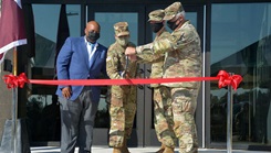 Military personnel cutting a ribbon at the new blood donor center