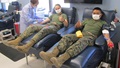 Military personnel donating blood