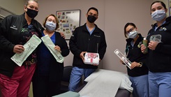 Five people wearing masks look at the camera.