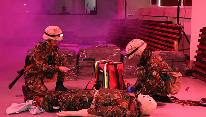 Two medics tend to a dummy in a simulated emergency.