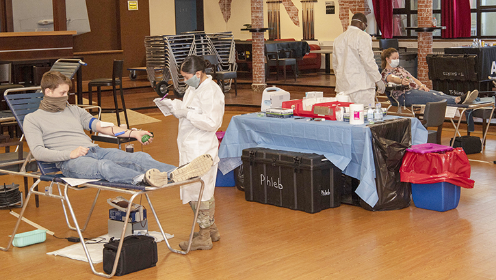 A service member donates convalescent plasma at a blood donation center.