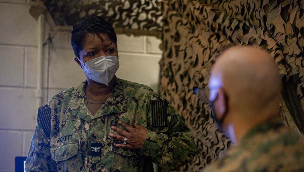 Medical military personnel talking to a patient