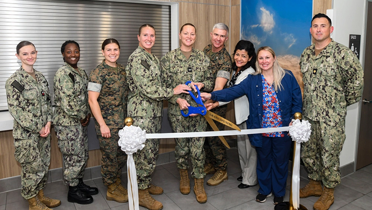 Leadership and clinic staff pose for a photo during the ribbon cutting ceremony