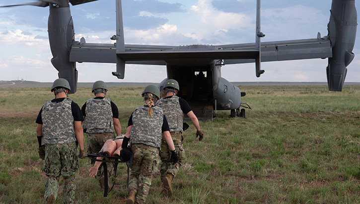 U.S. Air Force airmen carry a mannequin to a CV-22 Osprey assigned to the 20th Special Operations Squadron during exercise Medic Rodeo at Melrose Air Force Range, New Mexico, on Aug. 13, 2024. 