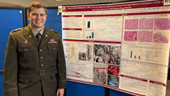 U.S. Army Capt Bradley Pierce, General Surgery Resident Physician at Tripler Army Medical Center, Honolulu, Hi. poses with his research Project on ECMO life support.