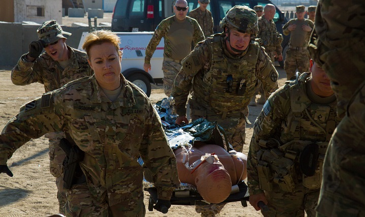 Soldiers participating in a trauma lane training exercise rush a simulated casualty to care at Camp Buehring, Kuwait. Along with U.S. Army Central personnel, service members from the Navy, Air Force and Canadian military took part in the weeklong trauma lanes to better prepare their medical personnel for a mass casualty situation. (U.S. Army photo by Sgt. Youtoy Martin)