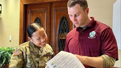 Pfc. Nhu Dang, a mental health specialist at Bayne-Jones Army Community Hospital, participates in a guided self-awareness exercise with Capt. David Rutkin, hospital chaplain, during a Building Strong and Ready Teams luncheon