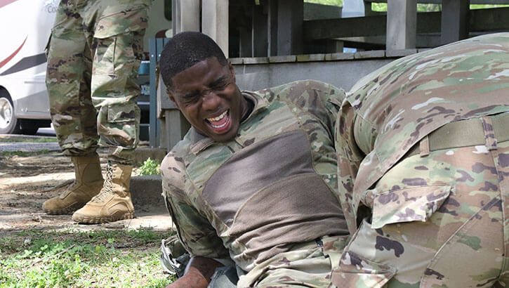 Military personnel fighting through the pain after a 12 mile ruck march