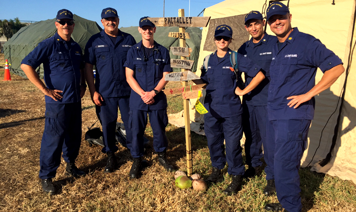A Coast Guard medical team oversees a temporary tent city set up in Key West, Florida, to shelter service members assisting with hurricane recovery efforts. Pictured left to right: Cmdr. Rob Kuhl, Capt. Ezequias Sanchez-Olmo, HS3 Christopher Roche, HS2 Lauren Coghill, HS2 Ivan Castro, and Cmdr. Justin Eubanks. (U.S. Coast Guard)