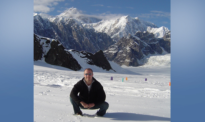 James Coker focuses on protecting service member health every day as deputy chief of the Public Health Division at the Defense Health Agency. Here he is exploring a Mount Denali glacier “off the clock” while stationed in Alaska as a public health flight commander at Elmendorf Air Force Base. (Courtesy photo) 