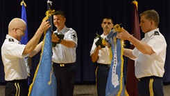 Military personnel unveiling flags