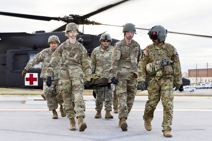 A group of combat medics unload a casualty from a MEDEVAC helicopter during a recent emergency medical evacuation training exercise at the hospitalâ€™s helipad here as part of the combat medicâ€™s individual critical task list training. (U.S. Army photo by Patricia Deal)