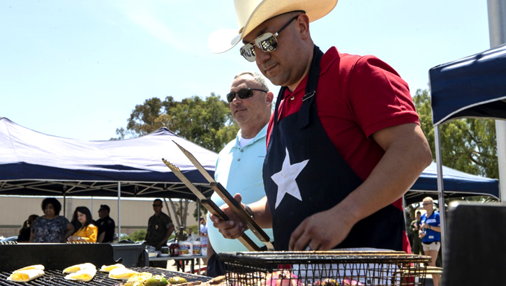 Marine Gunnery Sgt. Mario Cardenas, with Provost Marshal's Office, Headquarters and Headquarters Squadron, prepares lunch for the H&HS Barbecue Cook-off at Marine Corps Air Station Miramar, California. (U.S. Marine Corps photo by Lance Cpl. Andrew Hiatt)
