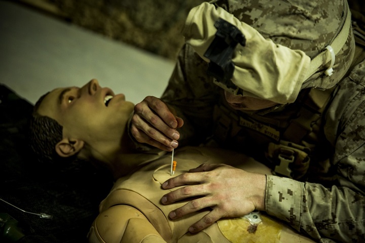Navy Seaman Brandon Taylor, a corpsman, inserts a decompression needle into an essential care simulator manikin during shock trauma section drills. The drills focused on sharpening life-saving skills and capabilities. (U.S. Marine Corps photo by Sgt. Justin Huffty)