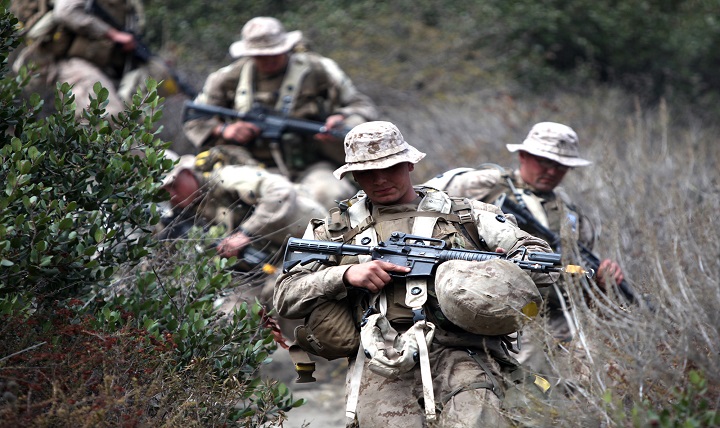 Navy corpsmen in training hike towards their next objective during a Field Medical Service Technician Course exercise.