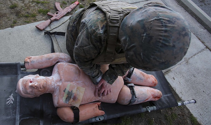 A corpsman checks for open wounds during a Tactical Combat Casualty Care training exercise. The TCCC is designed to give corpsmen the basic skills to work under pressure in a combat setting, ensure productive communication and save their patients’ lives. (U.S. Marine Corps photo by Cpl. Ashley Lawson)