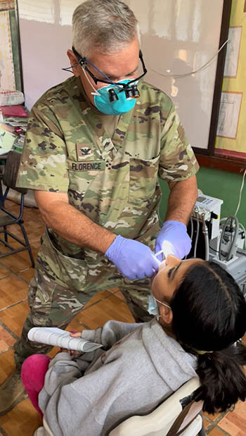 Army Col. Franklin Florence, general dentist with Army Forces Battalion, Joint Task Force-Bravo, performs an extraction on a young Honduran girl at Los Laureles, Santa Barbara department, Honduras, Feb. 15. Dental services were provided during a Global Health Engagement conducted by JTF-Bravo in conjunction with local Ministry of Health representatives and host nation volunteers. Additional services included preventive medicine, primary care, and pharmacy. 