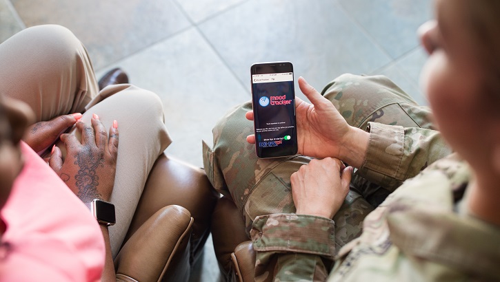 Military health care provider demonstrates the use of the T2 Mood Tracker app to a patient. 