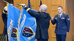 Two men unfold flags