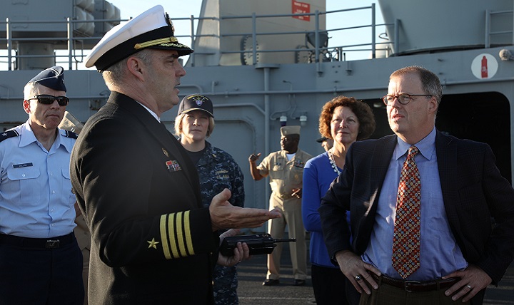 Thomas McCaffery (right), acting Assistant Secretary of Defense for Health Affairs, listens to a brief from Navy Capt. Todd Wagner (foreground, left), commanding officer of the Navy and Marine Corps Public Health Center. (U.S. Navy photo by Petty Officer 3rd Class Paul Wu)