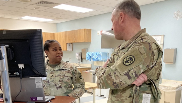 Army Medical Command East Command Sergeant Major Alexander Poutou, right, speaks with Sgt. Ashtin Josey in the Occupational Health clinic during a visit to Guthrie Ambulatory Health Care Clinic at Fort Drum, New York. (Photo: Ed Gulick)