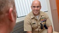 Image of naval captain talking to another military person