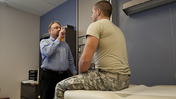 Dr. Gregory Johnson (right), Tripler Concussion Clinic medical director, has Army Spc. Andrew Karamatic, Department of Medicine combat medic, follow his finger with his eyes during a neurologic exam at Tripler Army Medical Center, Honolulu. (U.S. Air Force photo by Staff Sgt. Christopher Hubenthal)