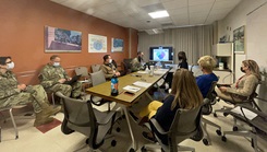 A group of people meet in a room.