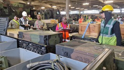 Military personnel conducting equipment inventory