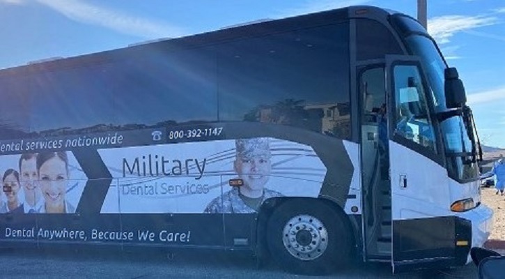 Image of a bus with the words "Military Dental Services" on the side.