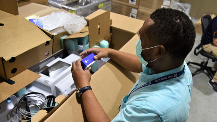 Medical equipment technician with a shipment of vital sign monitors