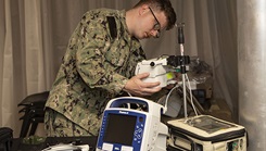 Corpsman disassembles equipment for pack up.