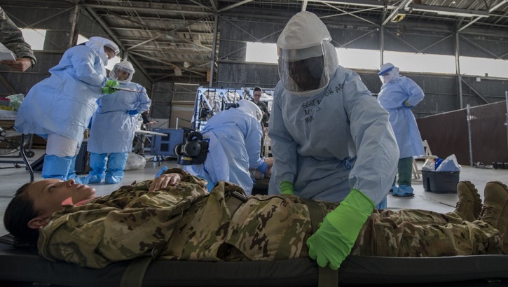 Air Force Staff Sgt. Lee Nembhard, an aeromedical evacuation technician assigned to the 375th Aeromedical Evacuation Squadron from Scott Air Force Base, Illinois, straps a simulated Ebola patient to a litter during a Transport Isolation System training exercise at Joint Base Charleston, South Carolina. (U.S. Air Force photo by Senior Airman Megan Munoz)