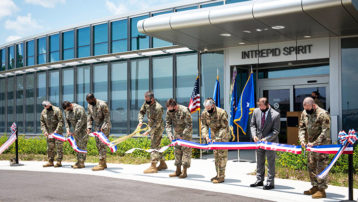 Image of Soldiers holding a long ribbon and cutting it. Click to open a larger version of the image.