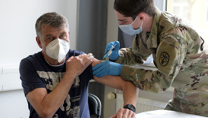 Franz Dietrich, a German local national assigned to Training Support Activity Europe, receives a COVID-19 vaccination at the 7th Army Training Command's (7ATC) Rose Barracks, Vilseck, Germany, May 4, 2021. The U.S. Army Health Clinics at Grafenwoehr and Vilseck conducted a "One Community" COVID-19 vaccine drive May 3-7 to provide thousands of appointments to the 7ATC community of Soldiers, spouses, Department of the Army civilians, veterans and local nationals employed by the U.S. Army. (U.S. Army photo by Markus Rauchenberger)
