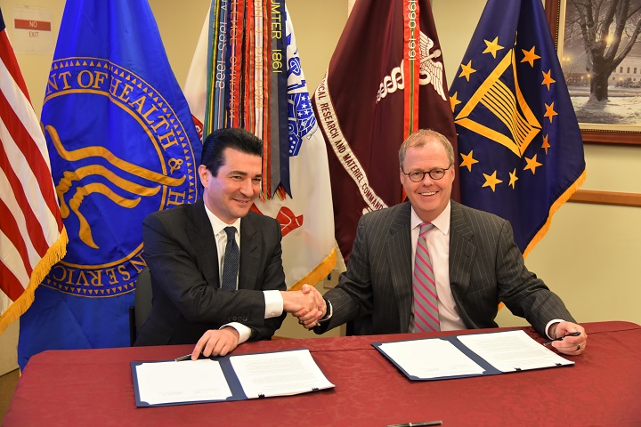 Dr. Scott Gottlieb, FDA Commissioner (left) and Mr. Thomas McCaffery, Principal Deputy Assistant Secretary of Defense (Health Affairs) (right), congratulate on another following the signing of a memorandum of understanding between the DoD and the FDA.  The ceremony acknowledges the existing partnership and the future collaboration on accessing life-saving medical products for U.S. troops on the battlefield.
