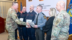 Fort Indiantown Gap firefighters: Assistant Chief Travis Duncan, Firefighter/EMT Jesse Berdanier, Firefighter/EMT Benjamin Condran; and Pennsylvania State Police Trooper Brody Myers receive the Clinical Save Award during a ceremony in the Hartranft Conference Room